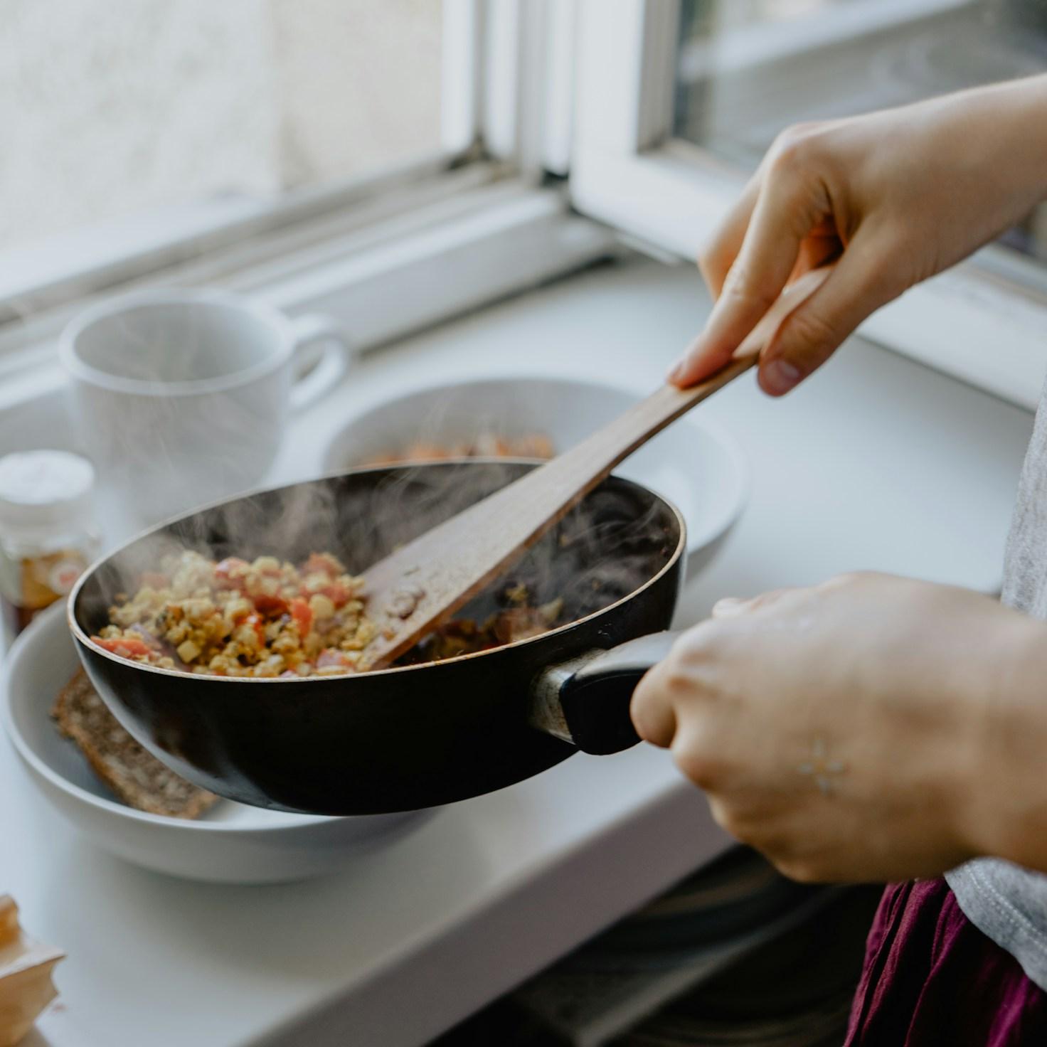 Diverse group of community members sharing a meal together, showcasing the social bonds formed through collaborative cooking
